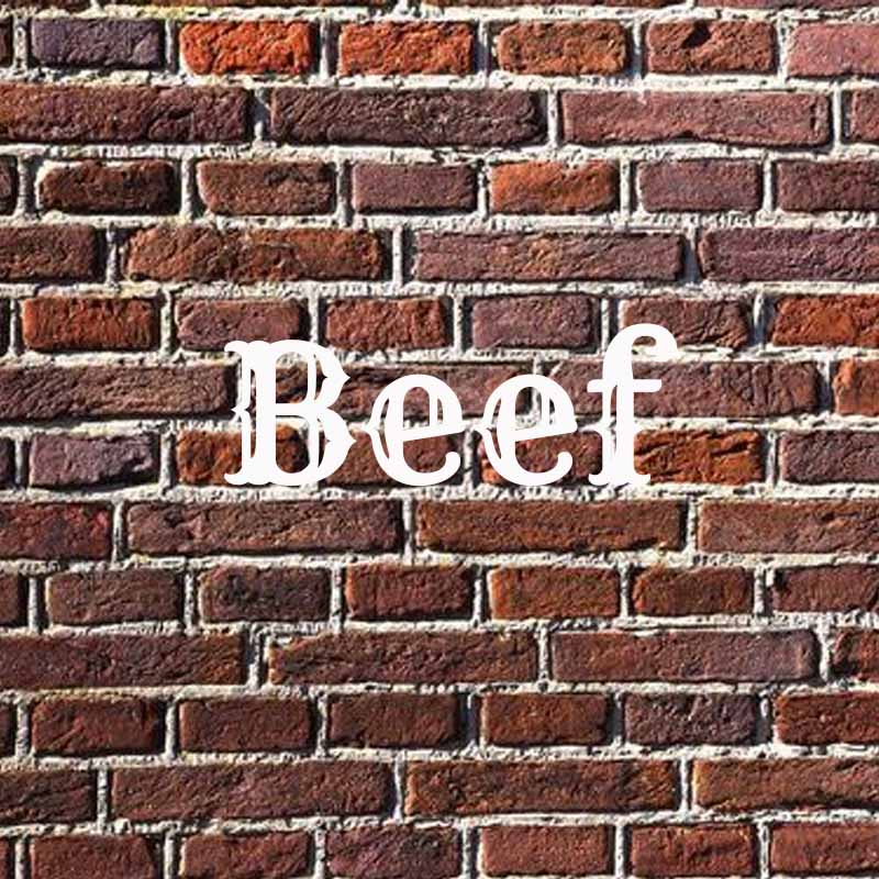 the word beef on a brick background