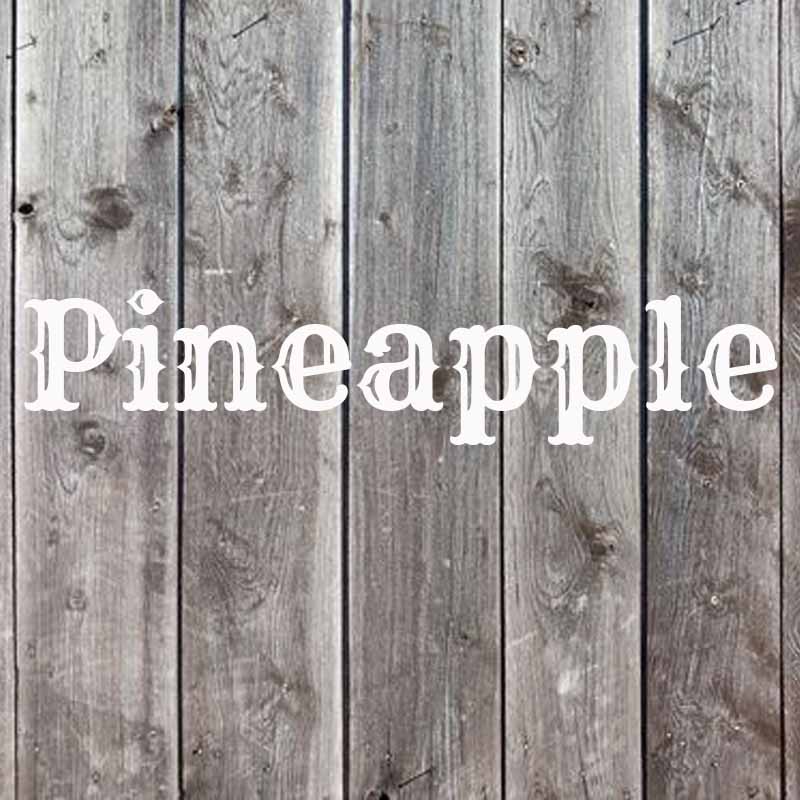 The word PIneapple on a faded wood background