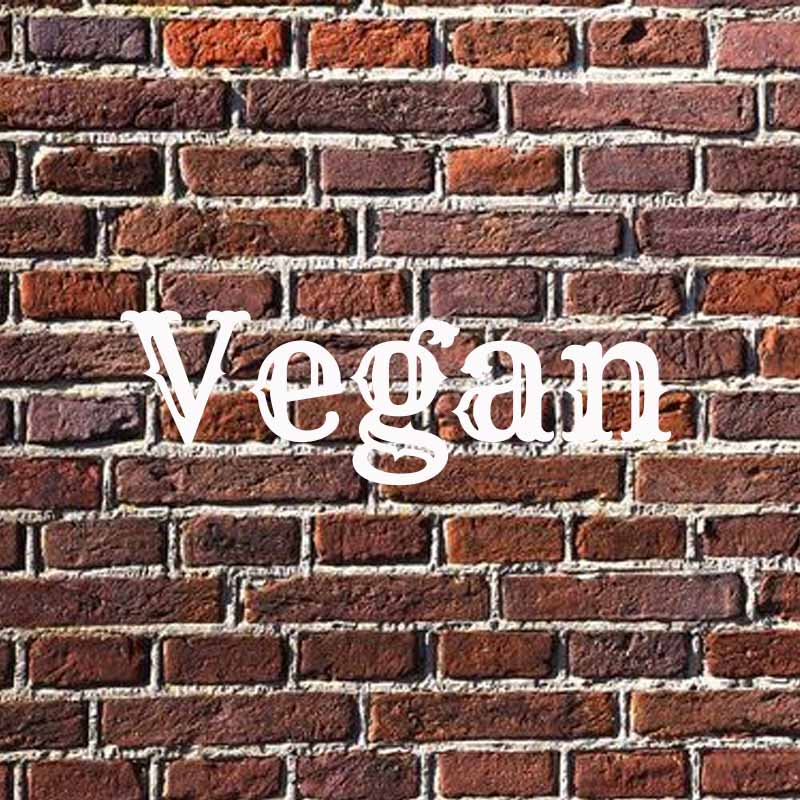 The word Vegan on a brick background